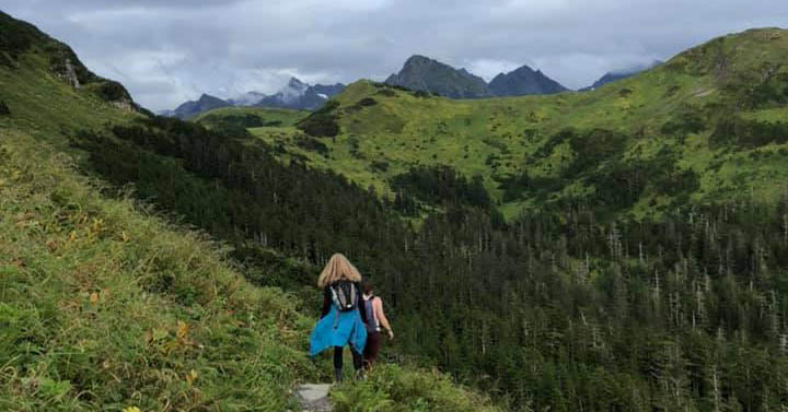 Women hiking down a mountain path when traveling in the Washington State